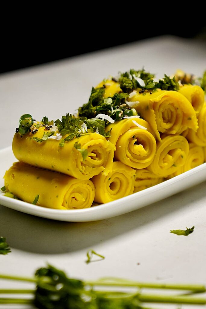 Rolled Khandvi snack showcasing its smooth texture and vibrant color.