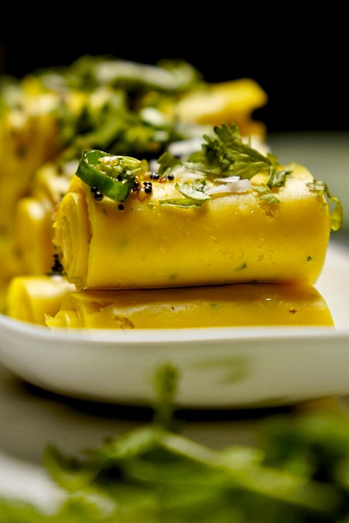 Tempering for Khandvi with mustard seeds and spices, adding flavor to the rolls.