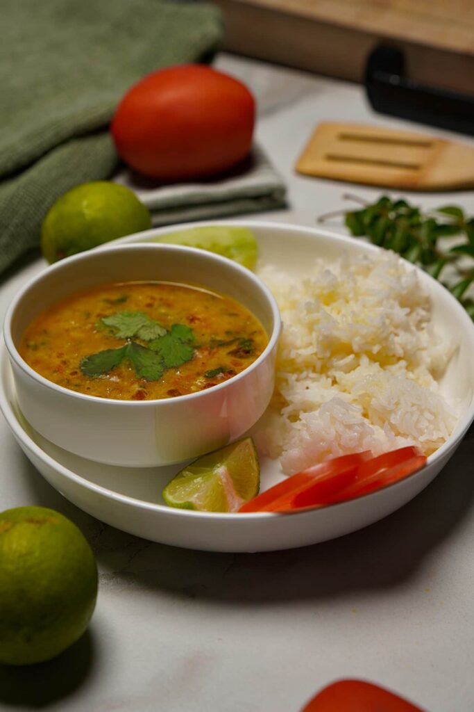 Jeera Tadka Wali Dal served with a side of salad, highlighting the vibrant colors of the dish.