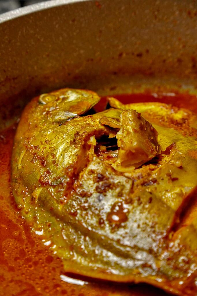 Close-up of delicious Pomfret Fish Curry, emphasizing the tender fish and flavorful gravy.