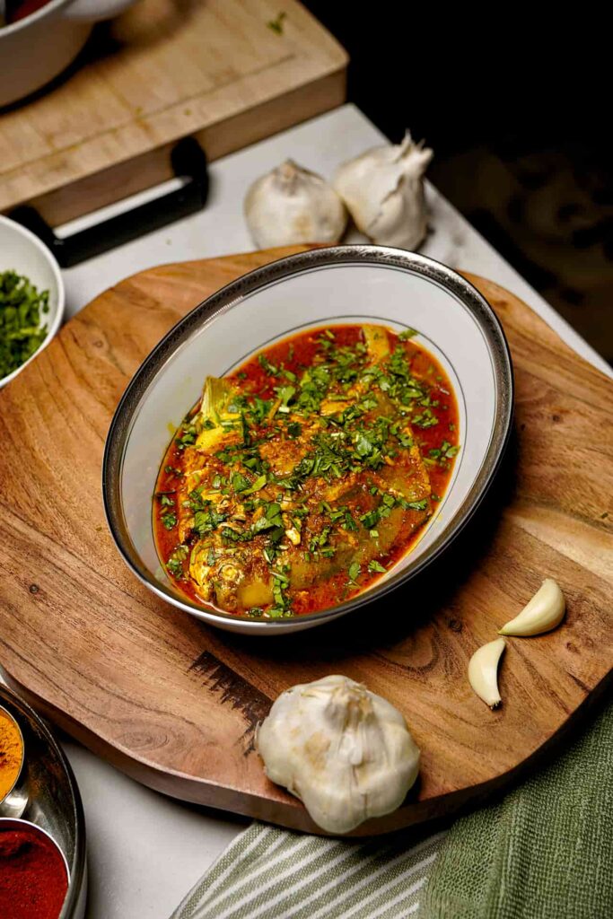 Overhead view of Pomfret Fish Curry, showcasing the rich colors and aromatic spices in the dish.